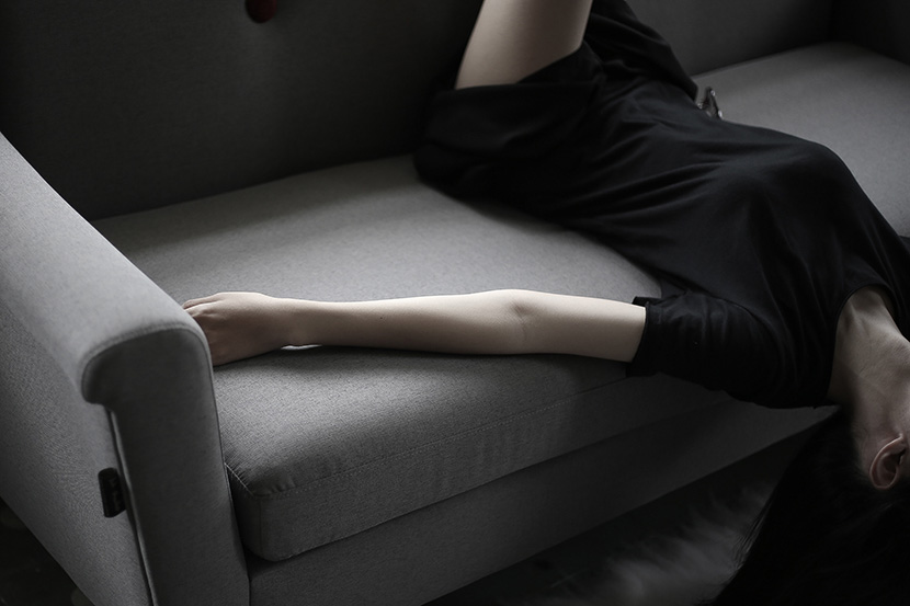倒卧在沙发上的黑衣女人
