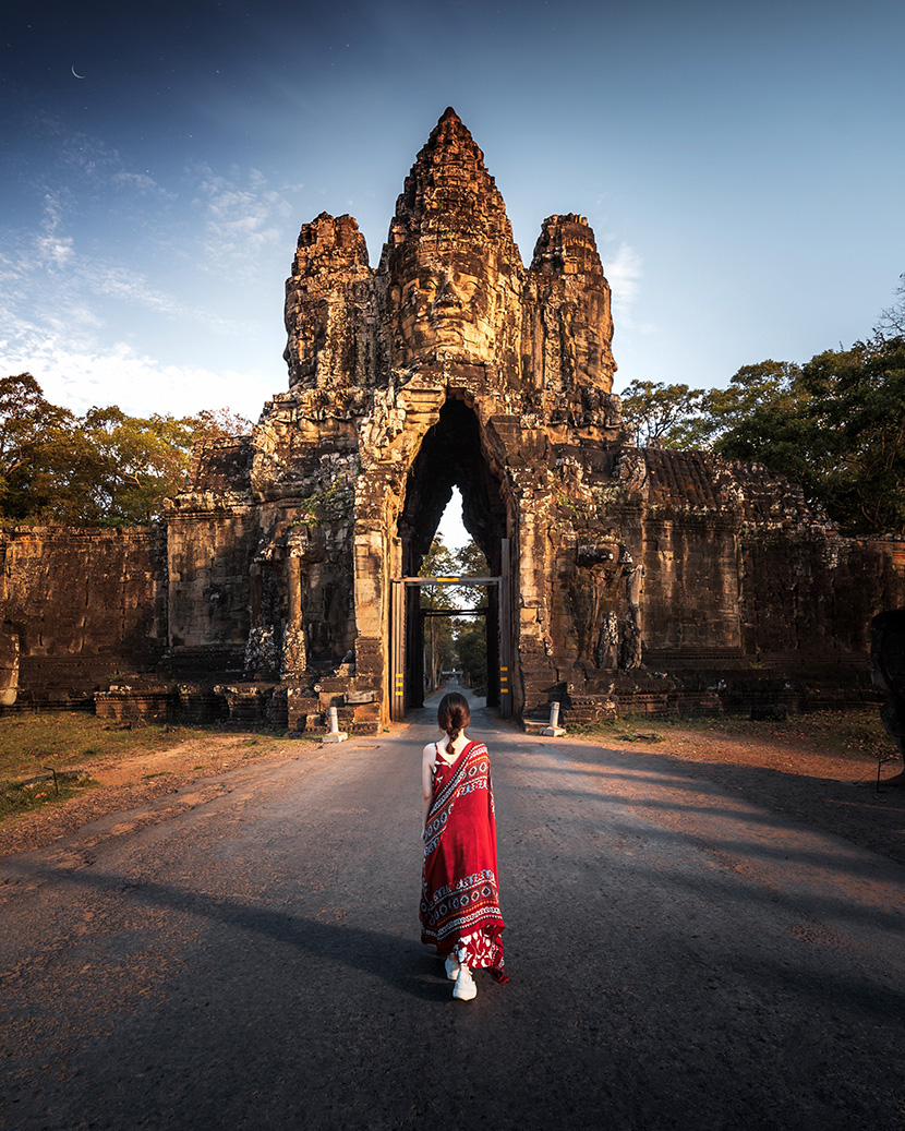 在柬埔寨吴哥古迹旅游的红衣少女